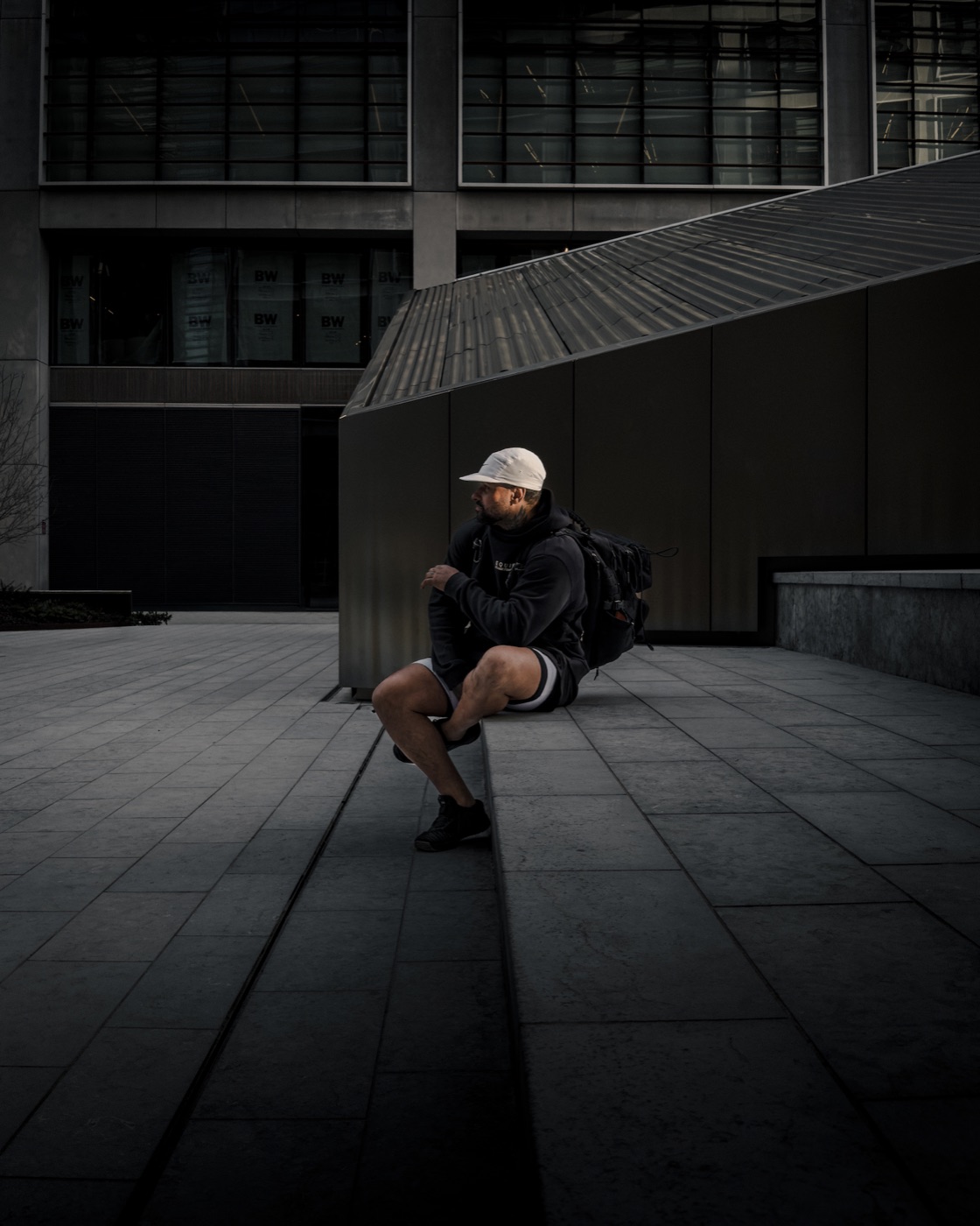 Theone Coleman seated outside a modern building